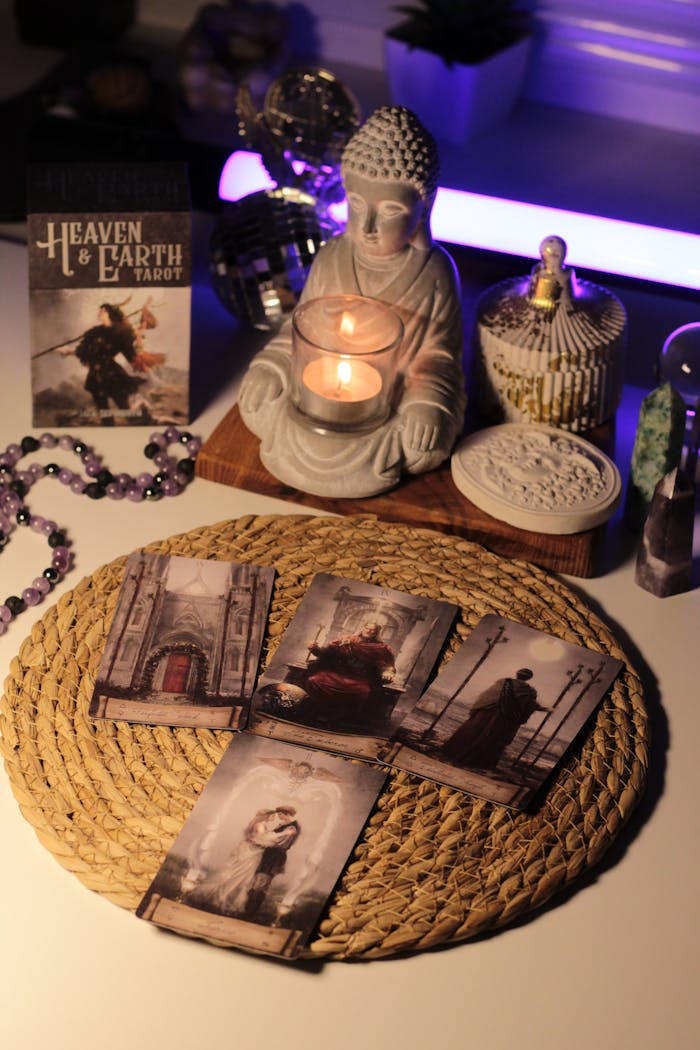 Cozy space featuring Buddha statue, tarot cards, and candles for meditation.