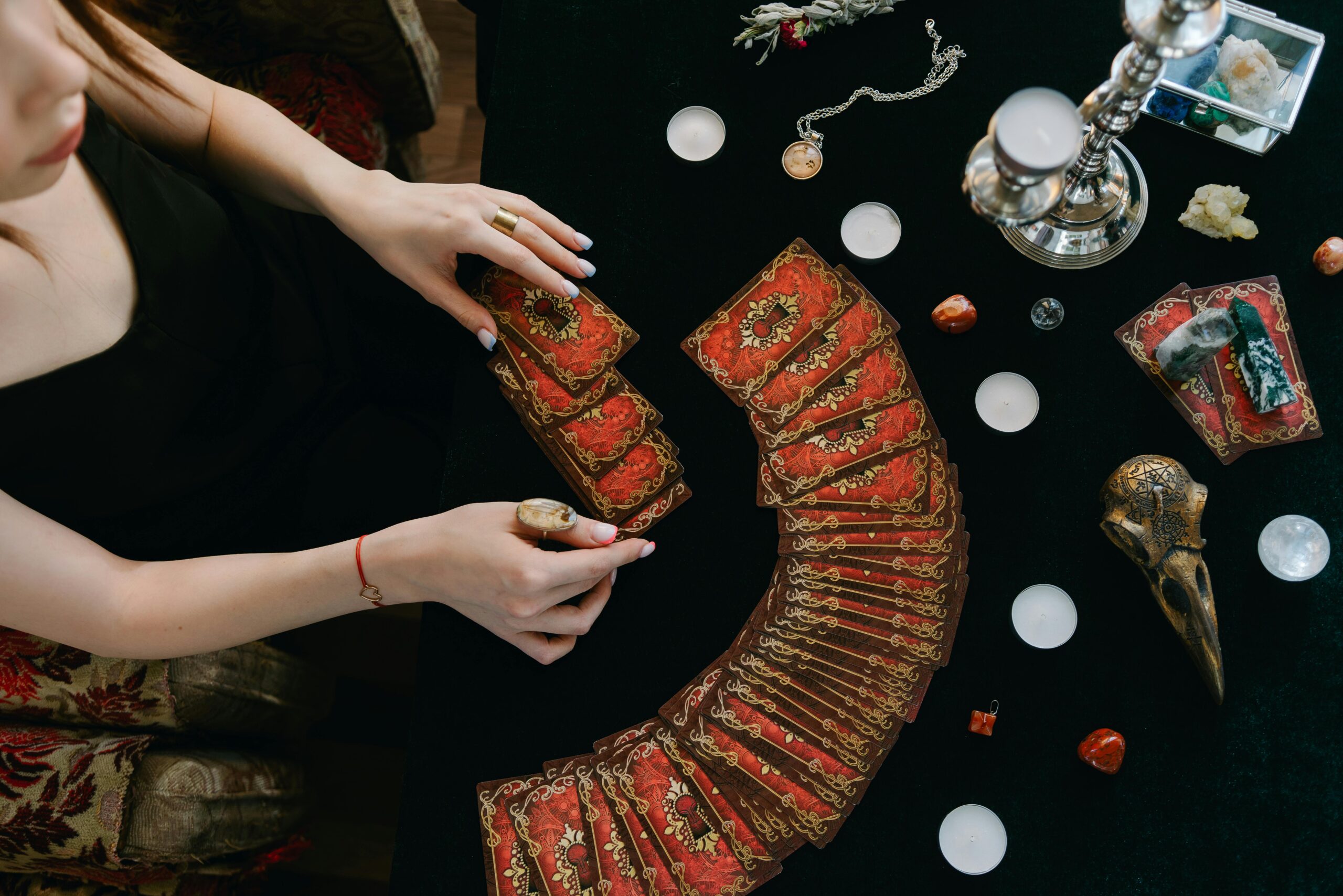 A mystical scene of tarot card reading with candles, offering fortune insights.